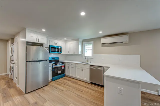 a kitchen with a refrigerator a stove top oven a sink and dishwasher