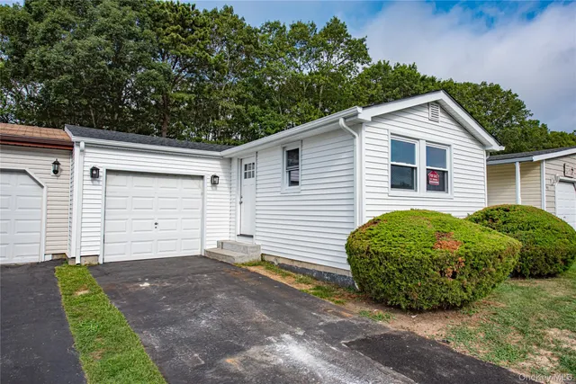 a view of a house with a yard and garage