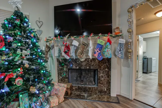 a bedroom with furniture and a chandelier fan
