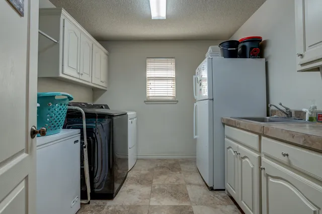 a bedroom with a bed a flat screen tv and a couch