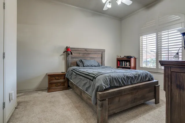 a bedroom with bed and a chandelier
