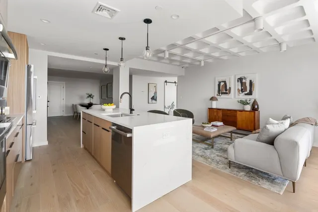 a living room with furniture and a chandelier