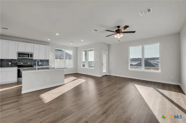 a view of kitchen with sink and wooden floor