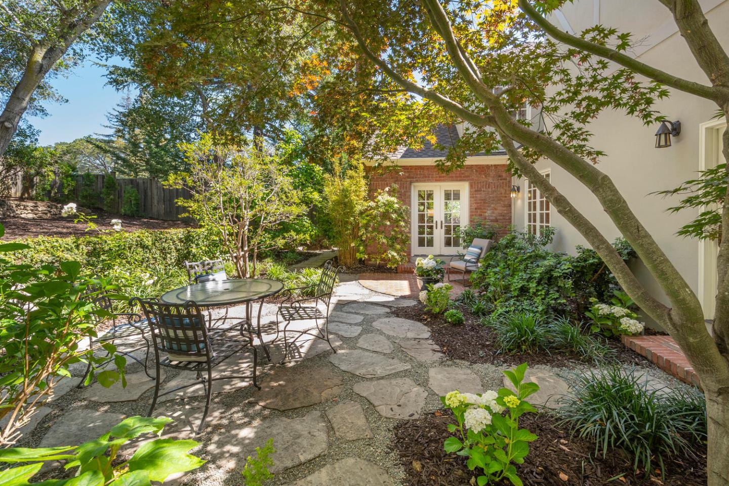 1055 Vista Road Hillsborough, CA 94010 - Photo 24 of 28 a backyard of a house with table and chairs