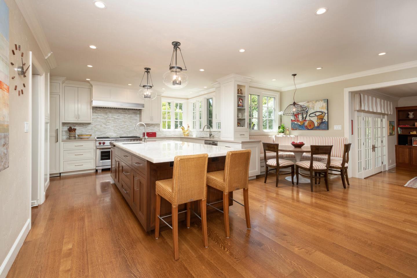 1055 Vista Road Hillsborough, CA 94010 - Photo 7 of 28 a large kitchen with a dining table chairs and wooden floor