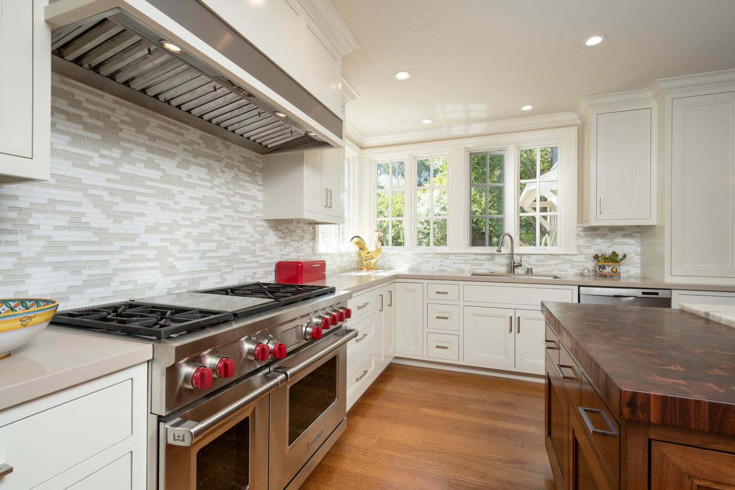 1055 Vista Road Hillsborough, CA 94010 - Photo 8 of 28 a kitchen with granite countertop stainless steel appliances a stove sink and cabinets