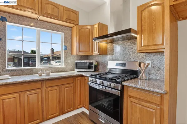 a kitchen with stainless steel appliances granite countertop a stove and a sink