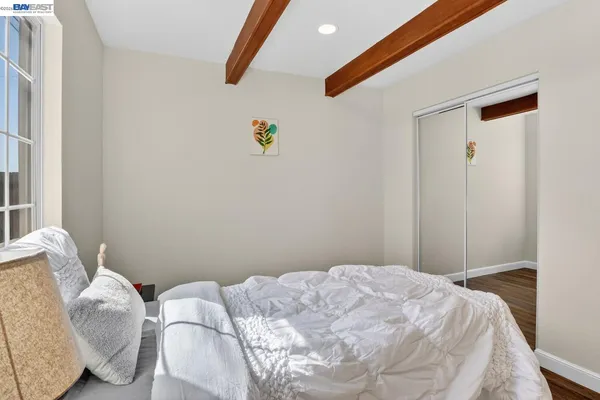 a bedroom with a bed and a window