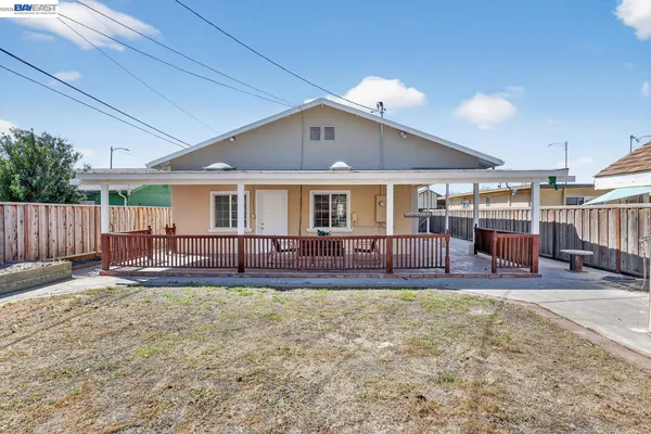 a view of a house with a yard and sitting area