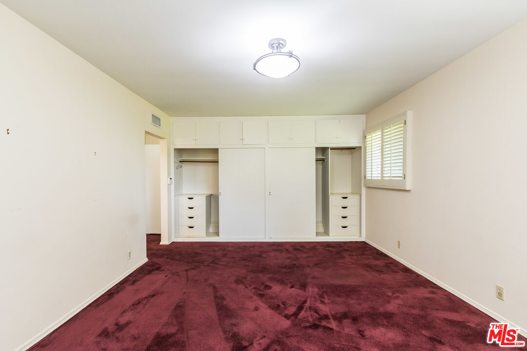 642 Elkins Road Los Angeles, CA 90049 - Photo 15 of 31 a view of empty room with wooden floor and fan