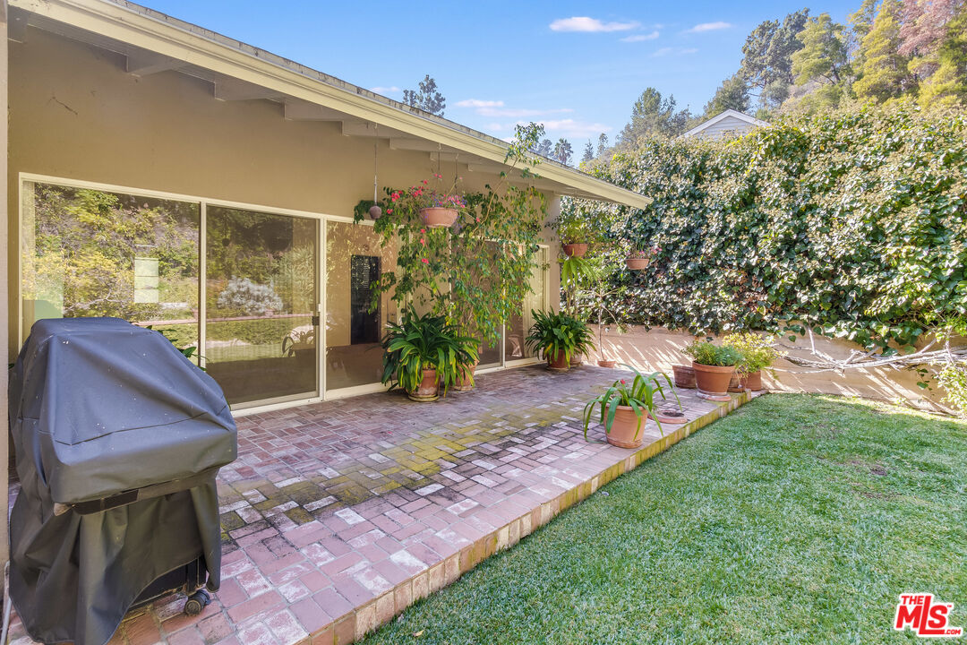 642 Elkins Road Los Angeles, CA 90049 - Photo 25 of 31 a view of a porch with furniture and a yard