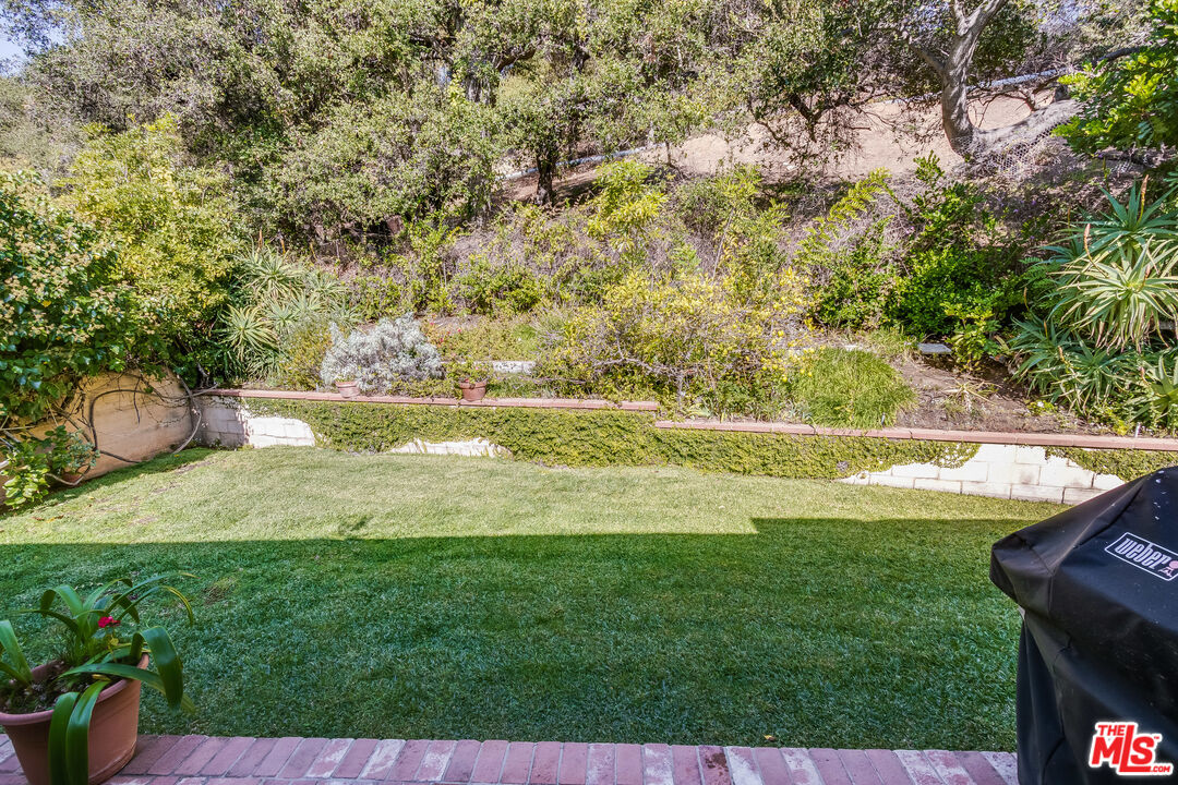 642 Elkins Road Los Angeles, CA 90049 - Photo 26 of 31 a view of yard with swimming pool and seating