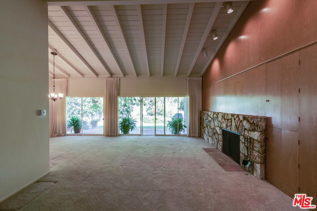 642 Elkins Road Los Angeles, CA 90049 - Photo 4 of 31 a view of empty room with a fireplace