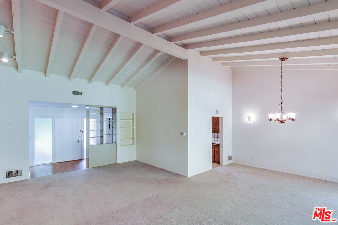 642 Elkins Road Los Angeles, CA 90049 - Photo 5 of 31 a view of a livingroom with a chandelier