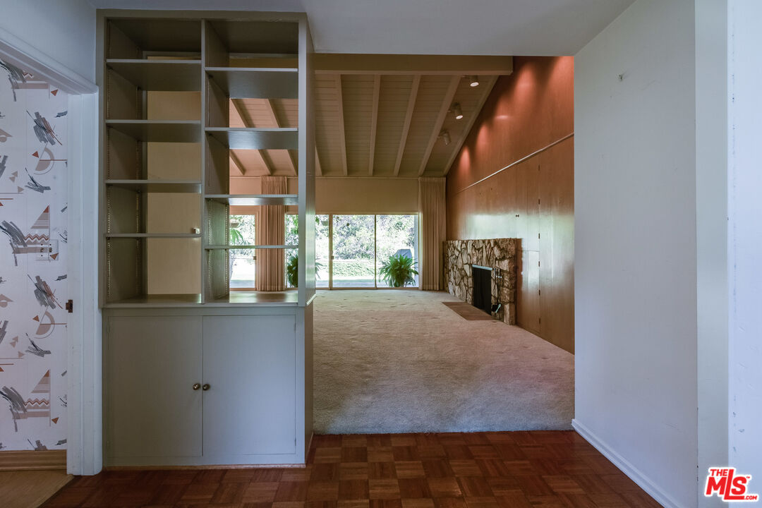 642 Elkins Road Los Angeles, CA 90049 - Photo 7 of 31 a view of empty room with wooden floor and fan