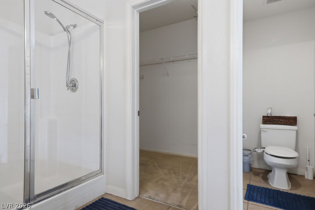754 Solitude Point Avenue Henderson, NV 89012 - Photo 32 of 38 A well-appointed bathroom offers both a standing shower and a private toilet area, conveniently adjacent to a walk-in closet.