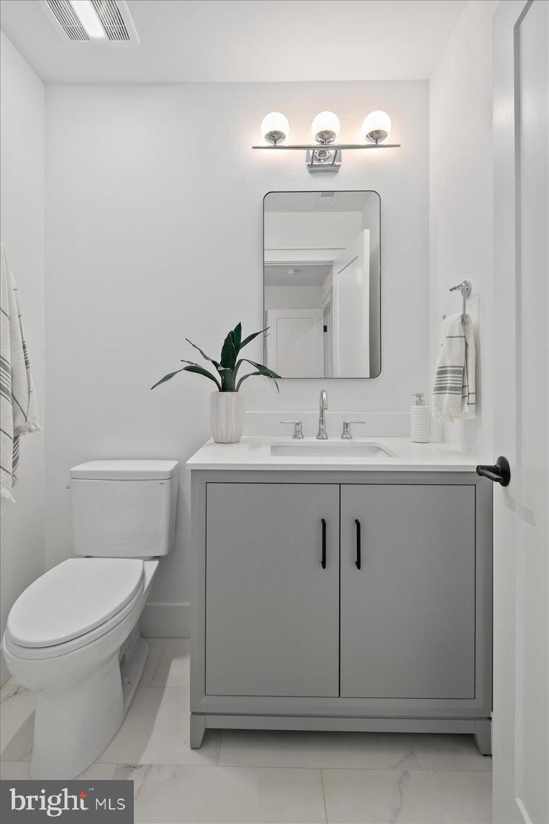 909 North Irving Street Arlington, VA 22201 - Photo 16 of 69 a bathroom with a toilet sink and mirror
