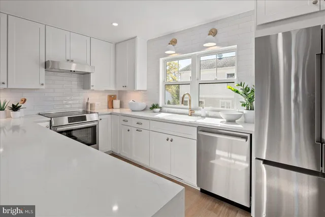 a kitchen with cabinets a sink and appliances