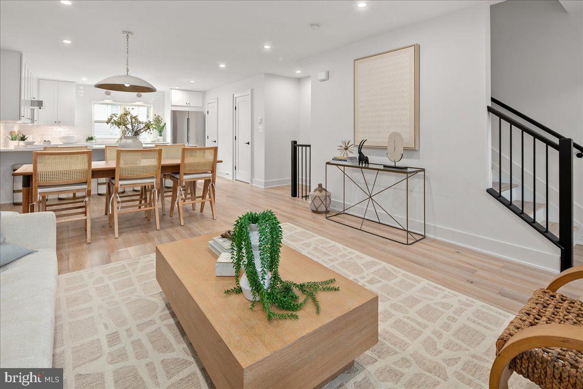 909 North Irving Street Arlington, VA 22201 - Photo 40 of 69 a living room with furniture a wooden floor and a chandelier