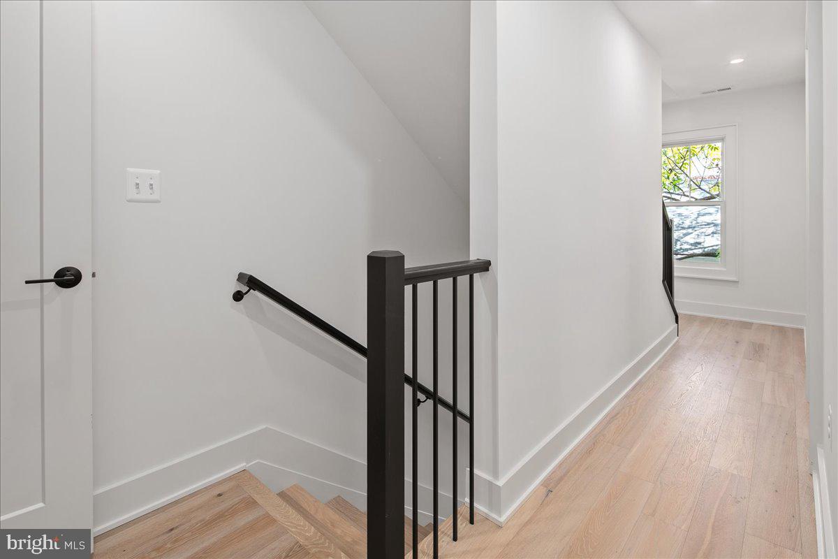 909 North Irving Street Arlington, VA 22201 - Photo 44 of 69 a view of a hallway with wooden floor and staircase