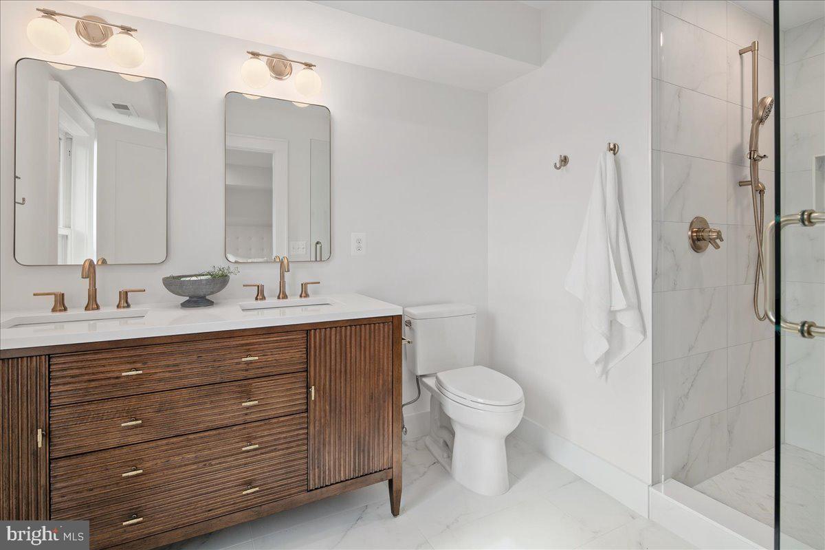 909 North Irving Street Arlington, VA 22201 - Photo 49 of 69 a bathroom with a sink a toilet and shower