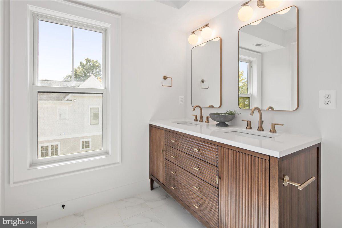 909 North Irving Street Arlington, VA 22201 - Photo 51 of 69 a bathroom with a sink vanity and a mirror