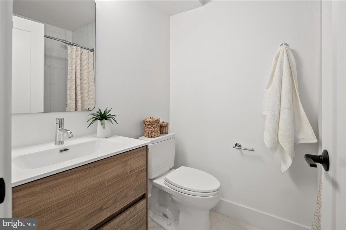 909 North Irving Street Arlington, VA 22201 - Photo 57 of 69 a bathroom with a sink a toilet and a mirror