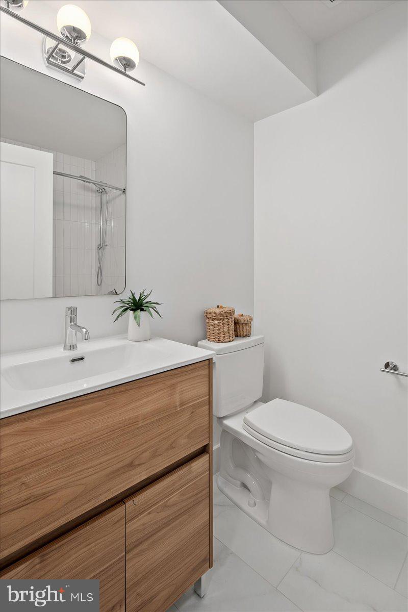 909 North Irving Street Arlington, VA 22201 - Photo 59 of 69 a bathroom with a toilet sink and mirror