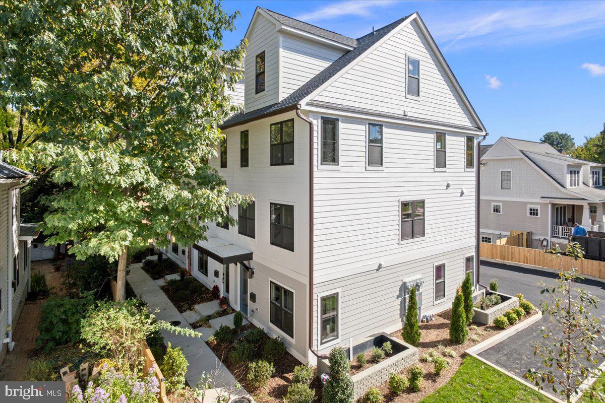 909 North Irving Street Arlington, VA 22201 - Photo 6 of 69 a view of a white house with large windows and couches chairs