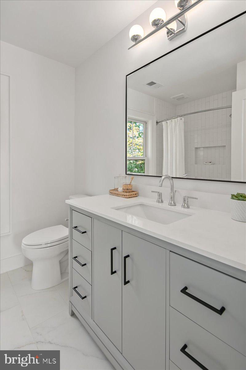 909 North Irving Street Arlington, VA 22201 - Photo 65 of 69 a bathroom with a sink a toilet and mirror