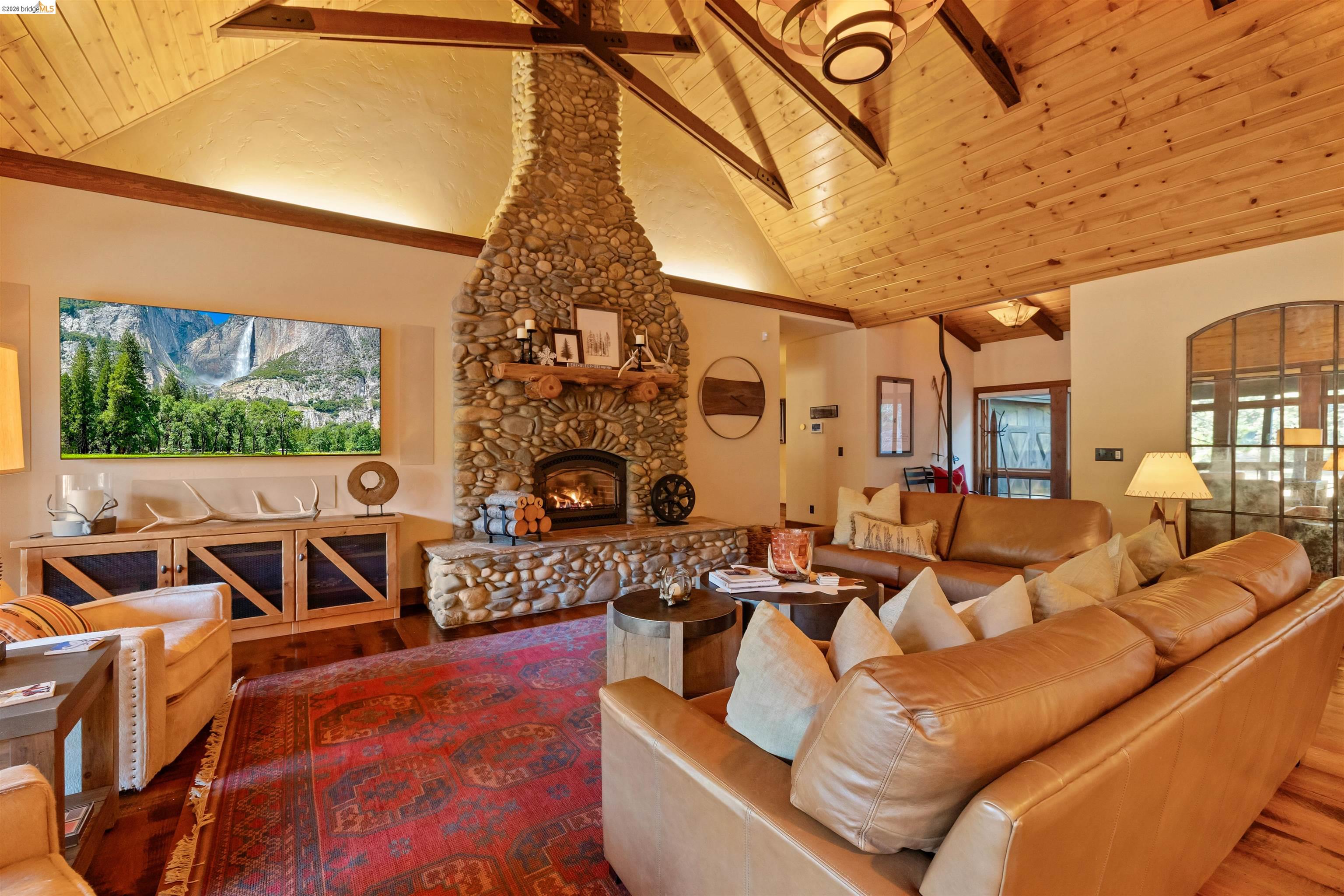 31631 Old Strawberry Road Strawberry, CA 95364 - Photo 8 of 17 a living room with furniture a fireplace and a flat screen tv