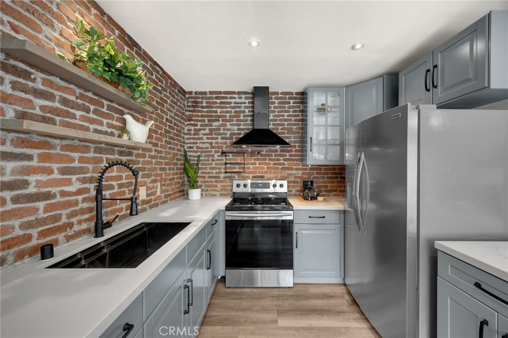621 Seneca Street Placentia, CA 92870 - Photo 9 of 29 a kitchen with stainless steel appliances granite countertop a stove and a refrigerator