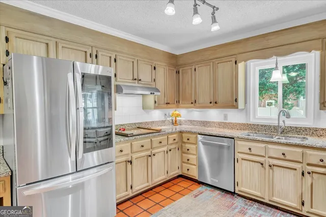 a kitchen with white cabinets and sink