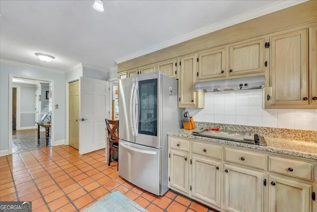 a kitchen with stainless steel appliances granite countertop a stove microwave and refrigerator