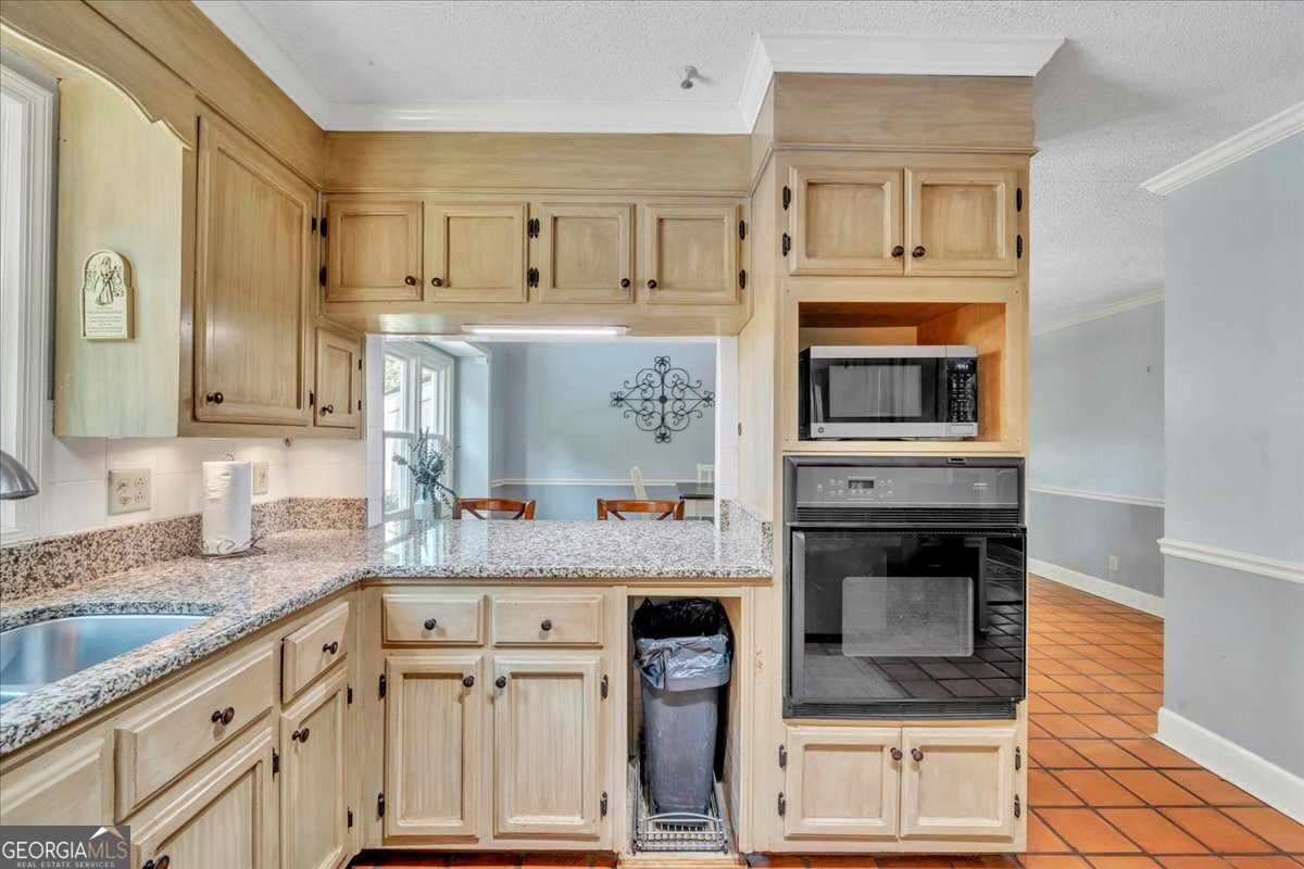 1808 Ross Street Perry, GA 31069 - Photo 17 of 56 a kitchen with stainless steel appliances granite countertop a stove microwave and refrigerator