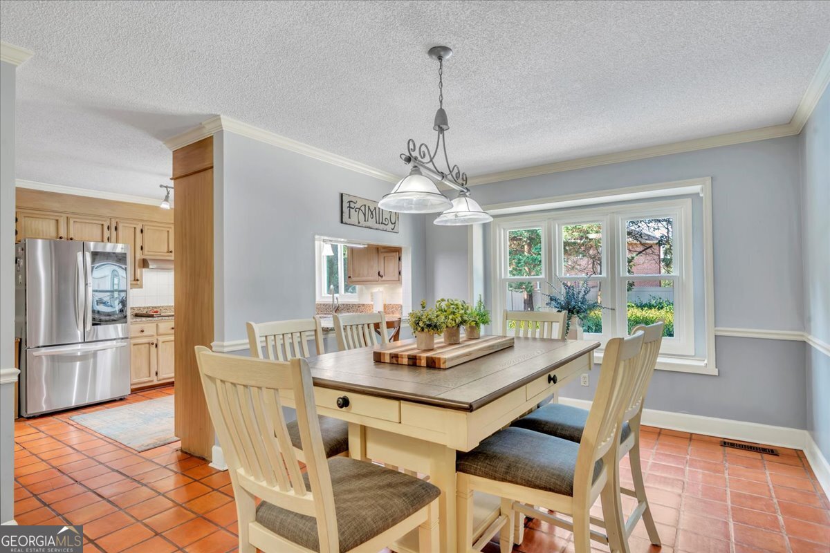 1808 Ross Street Perry, GA 31069 - Photo 19 of 56 a dining room with furniture a chandelier and wooden floor