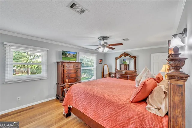 a living room with furniture and a painting on the wall