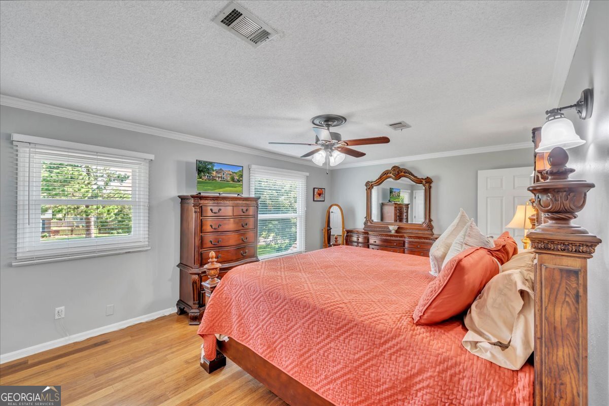 1808 Ross Street Perry, GA 31069 - Photo 28 of 56 a bedroom with a bed and wooden floor