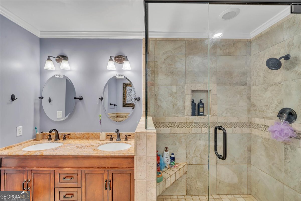 1808 Ross Street Perry, GA 31069 - Photo 31 of 56 a bathroom with a granite countertop sink a mirror and shower