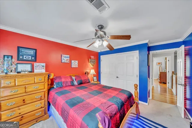 a spacious bedroom with a bed and a flat screen tv