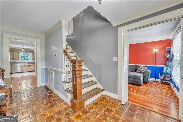 a view of a hallway with furniture and floor to ceiling window