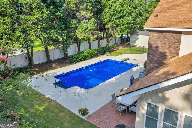 an aerial view of residential houses with outdoor space and swimming pool