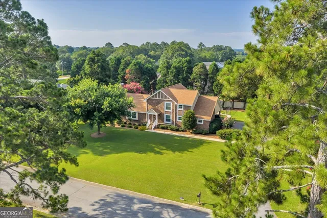 a view of house with swimming pool and outdoor seating