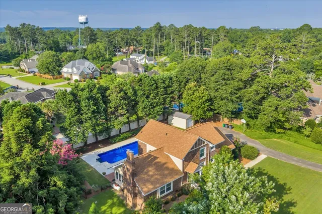 a view of a house with swimming pool and sitting area