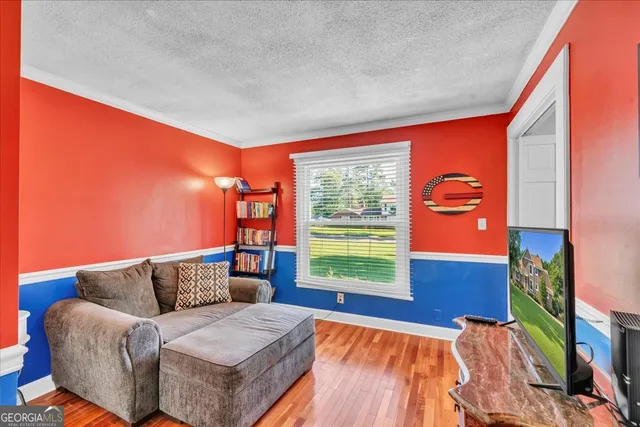 a dining room with furniture wooden floor and a rug