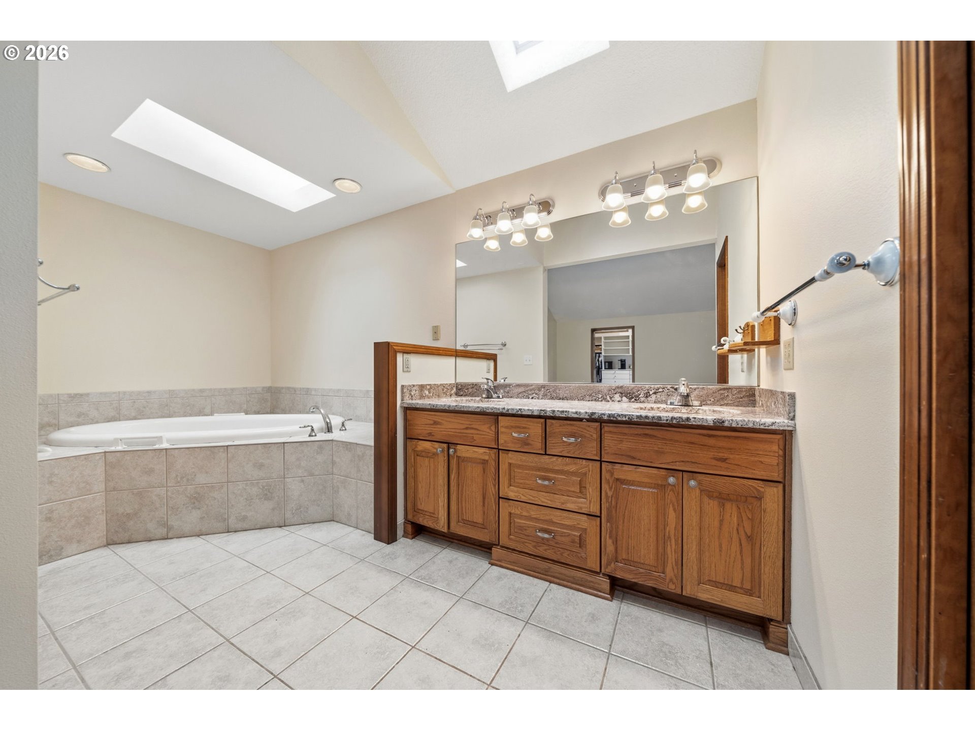 13825 Southwest Weir Road Beaverton, OR 97008 - Photo 16 of 40 a bathroom with a tub sink and mirror