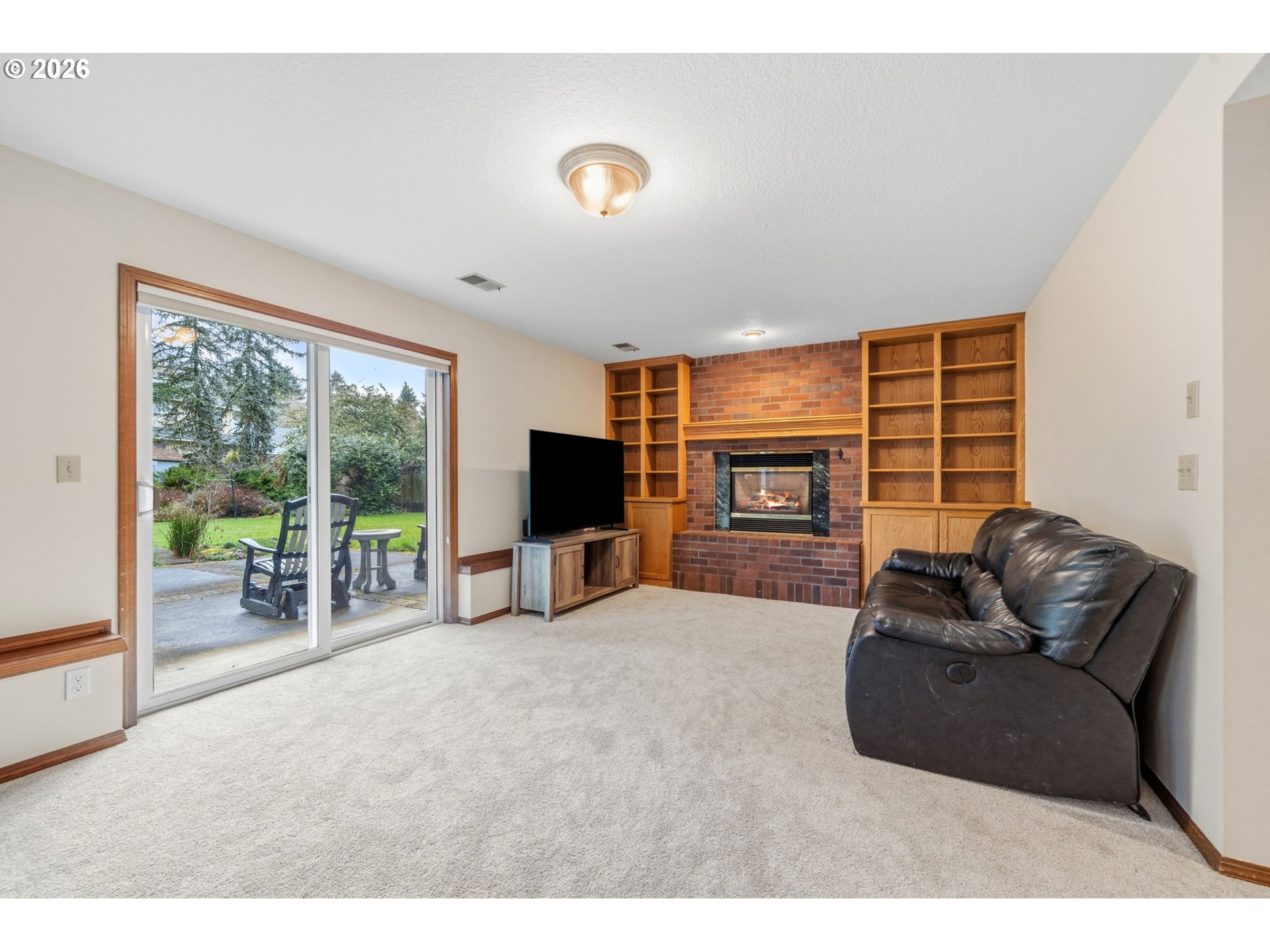 13825 Southwest Weir Road Beaverton, OR 97008 - Photo 25 of 40 a living room with furniture a flat screen tv and a large window