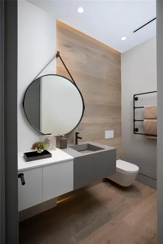 a bathroom with a toilet a sink and mirror