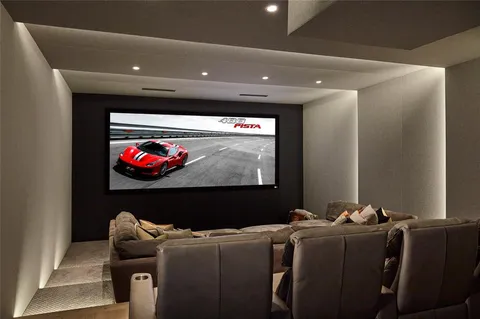 a room with furniture projector and screen