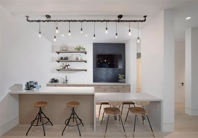 a kitchen with a table and chairs in it